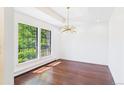 Sun-filled living room featuring hardwood floors and bright windows at 3957 S Peach Way, Denver, CO 80237