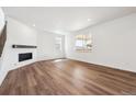 Spacious living room with wood floors, a fireplace, and lots of natural light at 24748 E 40Th Ave, Aurora, CO 80019