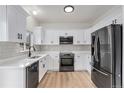 Modern kitchen featuring white cabinets, stainless steel appliances, and subway tile backsplash at 5010 Golden Eagle Pkwy, Brighton, CO 80601