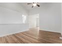 Light filled living room with hard wood floors, neutral paint, and view to hallway and other living areas at 5010 Golden Eagle Pkwy, Brighton, CO 80601
