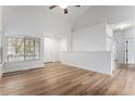 Bright living room boasts wood floors, vaulted ceilings, a front door, and plenty of natural light at 5010 Golden Eagle Pkwy, Brighton, CO 80601