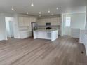Spacious kitchen with a large center island, stainless steel appliances, and white cabinetry at 7260 Waterleaf Trl, Littleton, CO 80125