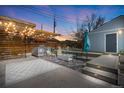 Inviting backyard with stylish pergola, outdoor kitchen, concrete patio and a cozy seating area with fire pit at 822 Poplar St, Denver, CO 80220