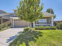 Charming home with a well-manicured lawn, cozy porch, and inviting curb appeal at 1290 W Quincy Cir, Englewood, CO 80110