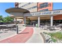 Inviting building entrance with manicured landscaping and outdoor seating area at 100 Park W Ave # 301, Denver, CO 80205