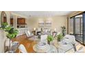 Open concept living and dining area with hardwood floors and natural light at 100 Park W Ave # 301, Denver, CO 80205