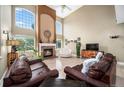 Bright living room with a fireplace, large windows, and hardwood floors at 5774 S Genoa Ct, Aurora, CO 80015