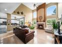 Elegant living room with a fireplace, high ceilings, and large arched windows at 5774 S Genoa Ct, Aurora, CO 80015