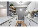 Modern kitchen with white cabinetry, sleek countertops, and stylish backsplash at 3047 W 47Th Ave # 105, Denver, CO 80211
