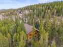 Secluded log home nestled among the trees offering privacy and a tranquil setting at 1673 Sinton Rd, Evergreen, CO 80439