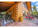 Inviting outdoor space with comfortable seating and log cabin details, perfect for enjoying scenic views and relaxation at 1673 Sinton Rd, Evergreen, CO 80439