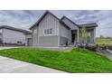Two-story home with stone accents, a well-manicured lawn and inviting front porch at 788 Alumroot St, Castle Rock, CO 80104