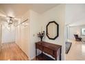 Bright hallway featuring beautiful hardwood floors, a wooden console table, and closet for storage at 1551 Larimer St # 1402, Denver, CO 80202