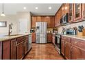 Chef's kitchen featuring granite countertops, stainless steel appliances and wood flooring at 2043 S Cathay Way, Aurora, CO 80013