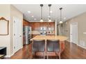 Spacious kitchen with wood cabinets, granite countertops, stainless steel appliances and an island with seating at 2043 S Cathay Way, Aurora, CO 80013