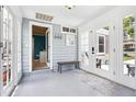 Inviting entryway featuring bright doors, a wooden bench, and stylish decor, creating a warm welcome at 9630 W 38Th Ave, Wheat Ridge, CO 80033