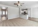 Open-concept living room and kitchen with modern finishes and plenty of natural light at 819 Sunflower Dr, Brighton, CO 80601