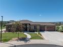 Beautiful single-story home featuring stone accents, a landscaped yard, and a two-car garage on a sunny day at 372 Castlemaine Ct, Castle Rock, CO 80104