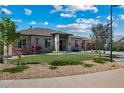 Charming single-story home with well-maintained lawn, rock features, and stucco exterior on a sunny day at 372 Castlemaine Ct, Castle Rock, CO 80104