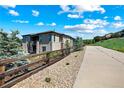 Two-story home featuring stone accents and a wood fence, set in a beautiful community on a sunny day at 372 Castlemaine Ct, Castle Rock, CO 80104