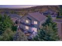 Aerial view of the back of the home showing the backyard landscaping and private patio at 3779 Aspen Hollow Ct, Castle Rock, CO 80104