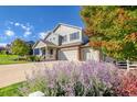 Charming two-story home with a welcoming front porch and a three-car garage at 3779 Aspen Hollow Ct, Castle Rock, CO 80104