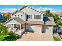 Charming two-story home with a welcoming front porch and a three-car garage at 3779 Aspen Hollow Ct, Castle Rock, CO 80104