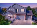 Inviting two-story home with a cozy front porch, perfect for enjoying the outdoors in the evening at 3779 Aspen Hollow Ct, Castle Rock, CO 80104