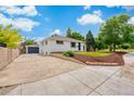Charming house featuring a detached garage, lush front yard, and meticulous landscaping at 1330 Quebec St, Denver, CO 80220