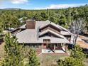 Charming wood home surrounded by lush trees offers great curb appeal at 18940 Pebble Beach Way, Monument, CO 80132