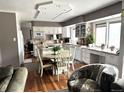 Open kitchen featuring an island, granite countertops, stainless steel appliances, white cabinets and an eating nook at 13126 W Warren Cir, Lakewood, CO 80228