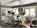 Open kitchen featuring an island, granite countertops, stainless steel appliances, white cabinets and an eating nook at 13126 W Warren Cir, Lakewood, CO 80228