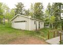 Spacious detached garage with a large door and side windows, perfect for storage at 29055 S Sunset Trl, Conifer, CO 80433