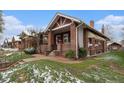 Charming brick bungalow featuring a covered front porch, landscaped yard, and beautiful architectural details at 3159 36Th Ave, Denver, CO 80211