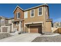 Two-story home featuring a two-car garage and covered porch with stone accents at 926 W Beverly St, Elizabeth, CO 80107