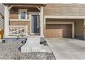 Inviting home entrance with stylish front door, stone accents, and covered porch at 926 W Beverly St, Elizabeth, CO 80107