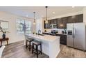 Modern kitchen with stainless steel appliances, center island, and stylish pendant lighting at 926 W Beverly St, Elizabeth, CO 80107