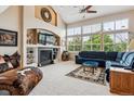 Spacious living room with fireplace, large windows overlooking nature, and comfortable seating arrangements at 26155 E Euclid Dr, Aurora, CO 80016