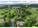 Aerial view of property near championship and par 3 golf courses, a clubhouse, and community pool with tennis at 1 Club Ln, Littleton, CO 80123