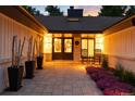 Inviting front porch with double doors, rocking chairs, and decorative plants for a cozy entrance at 1 Club Ln, Littleton, CO 80123