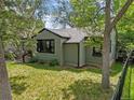 A side view of a quaint single-story home with manicured lawn surrounded by privacy fence at 5355 S Windermere St, Littleton, CO 80120