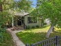 Charming single-story home with a well-maintained lawn, sidewalk, and mature trees at 5355 S Windermere St, Littleton, CO 80120