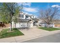 Lovely two-story home with a three-car garage and lush landscaping, offering a perfect blend of comfort and style at 9877 Arthur Ln, Highlands Ranch, CO 80130