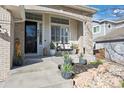 Welcoming front porch with a swing and manicured landscaping, offering a charming curb appeal and relaxation at 9877 Arthur Ln, Highlands Ranch, CO 80130