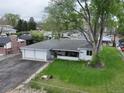 Charming single-story home with a well-maintained lawn and two-car garage at 14185 W 50Th Ave, Golden, CO 80403