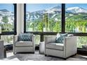 Relaxing living room with mountain views and comfy armchairs at 52 West Point Lode # A, Breckenridge, CO 80424