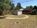 Backyard with detached shed, bordered by a wood fence at 3054 Victor St, Aurora, CO 80011