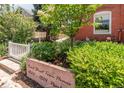 Landscaped front entrance with address sign, greenery, and a glimpse of the building's brick facade at 1824 Pearl St # B, Boulder, CO 80302