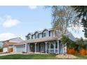 Inviting exterior view of a two-story home with a covered front porch and landscaped yard at 12945 E Colorado Ave, Aurora, CO 80012