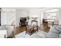 Cozy living room with hardwood floors, a white sofa, and an inviting atmosphere at 12945 E Colorado Ave, Aurora, CO 80012